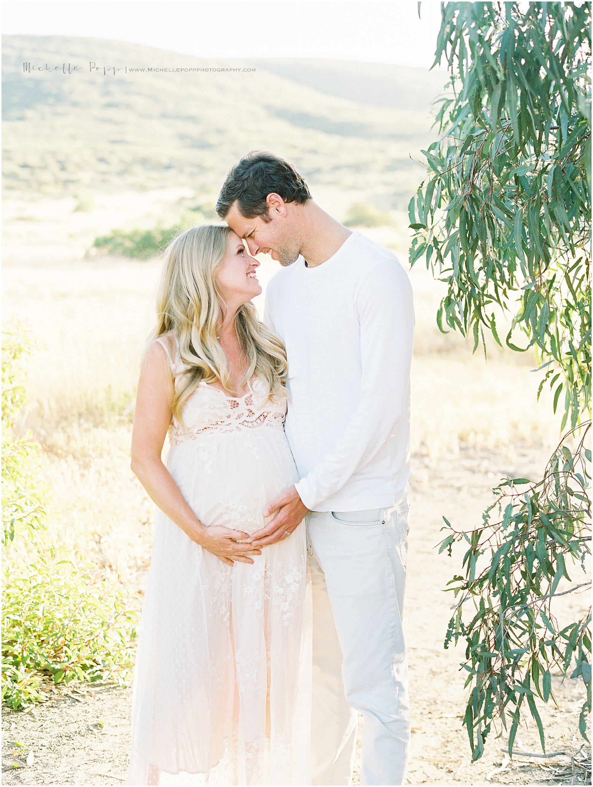mom and dad soaking in moment in maternity photo