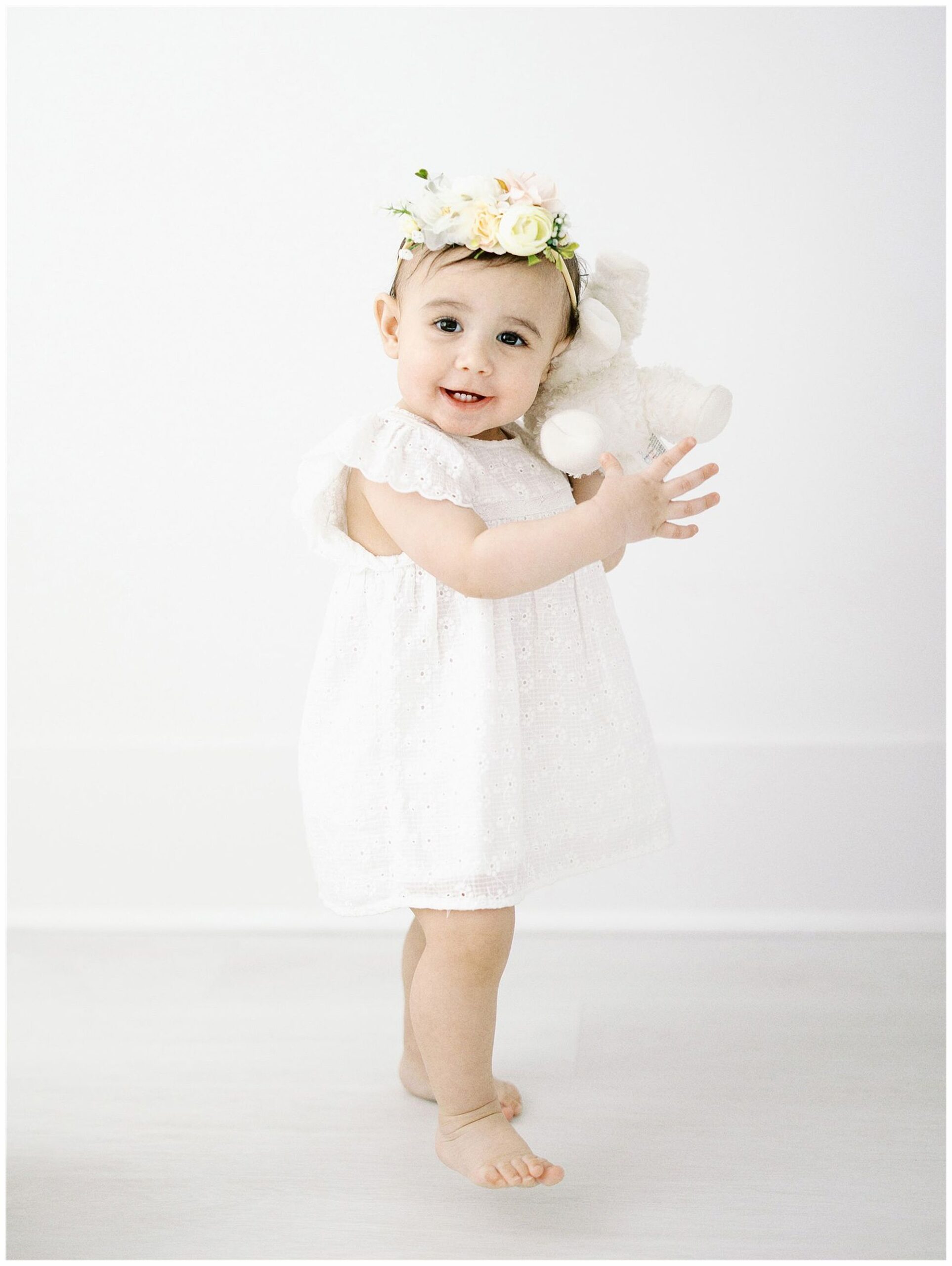 one year old in studio walking